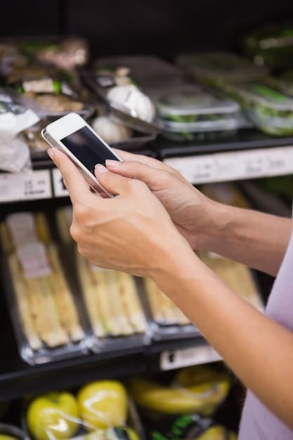 A close-up of an EBT card being used at a grocery store checkout. Focus on the card and the point-of-sale terminal, with groceries slightly blurred in the background.