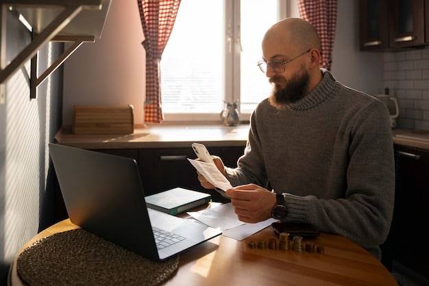 A person working on a budget, using a calculator and reviewing bills and receipts. The setting is a home office with a laptop in the background.