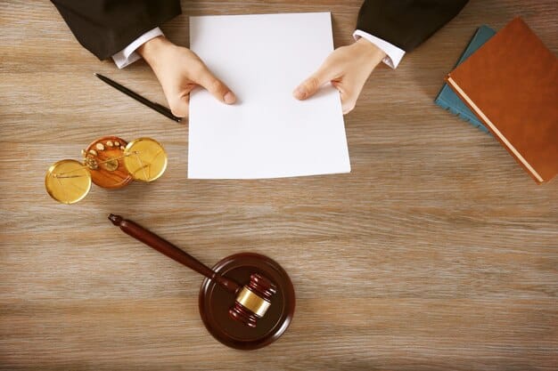 A gavel hitting a sounding block, with a blurred background of legal documents. The image represents the legal challenges and debates surrounding student loan forgiveness programs.