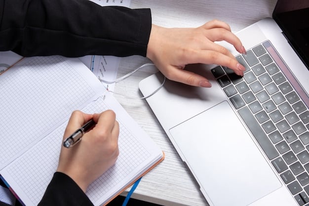 A close-up of a person reviewing documents related to state benefit programs on a laptop, with a pen and notepad nearby, symbolizing research and analysis.