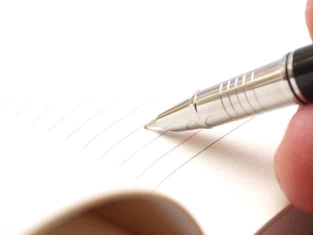 A close-up of an application form with a pen hovering over the signature line, symbolizing the process of applying for government assistance. The image is focused and professional.