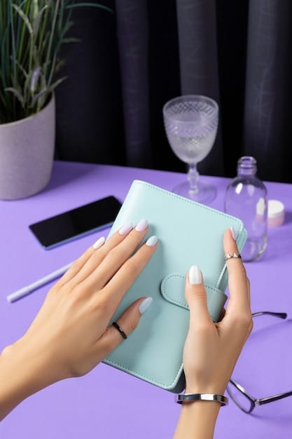 A close-up shot of a hand holding a paycheck, with a calculator and budget planner in the background. The image conveys the importance of income and financial stability in determining TANF eligibility.