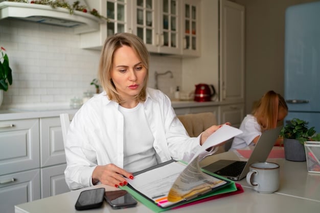 A single mother looking concerned while reviewing a stack of bills at her kitchen table. Her young child is sitting nearby, coloring in a book. The scene conveys the stress of managing finances on a limited income.