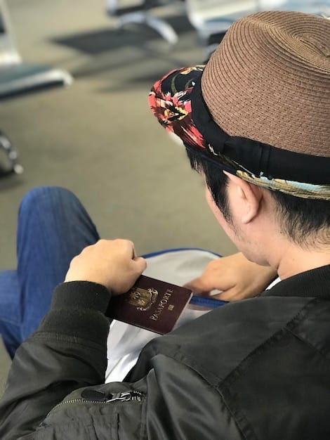 A clear, close-up shot of a passport's identification page, highlighting the photo, name, date of birth, and expiration date, emphasizing the importance of valid ID for application purposes.